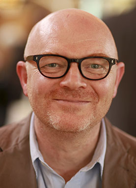 A headshot of author Andrew Cowan